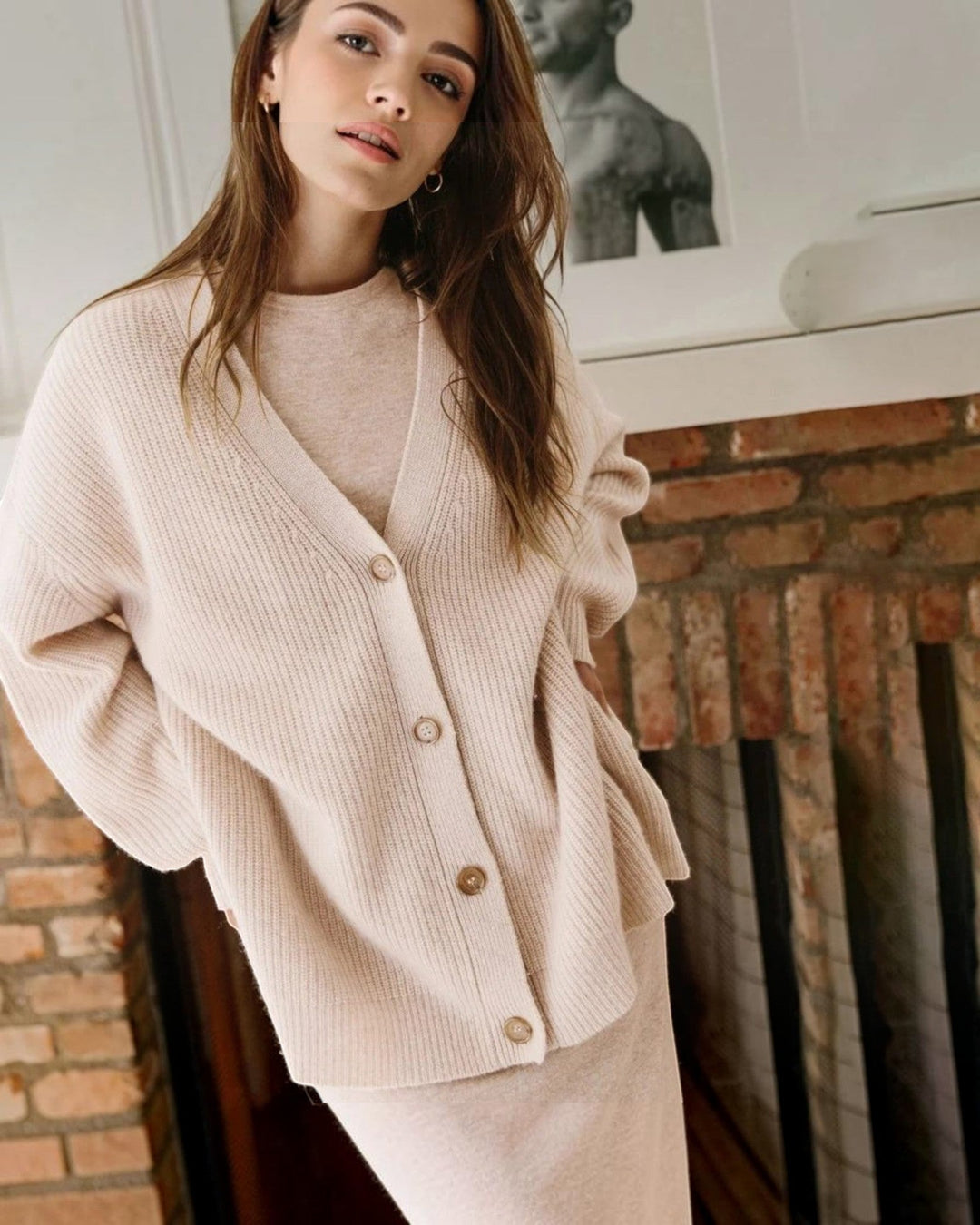 Luna Moda beige cashmere V-neck cardigan with button-up front worn by a woman in a cozy indoor setting