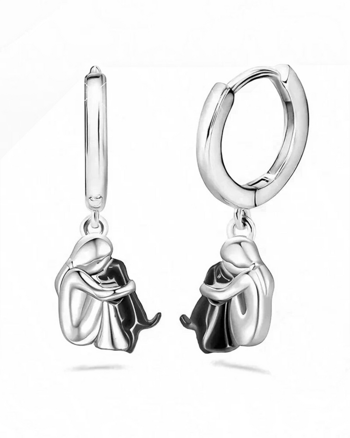 Luna Moda silver and gold-toned hoop earrings featuring a charming design of a person hugging their dog