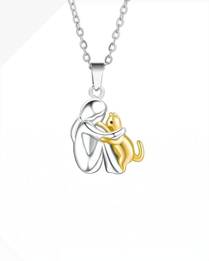 Luna Moda cat hug necklace featuring a silver human figure embracing a gold cat pendant on a 42 cm chain
