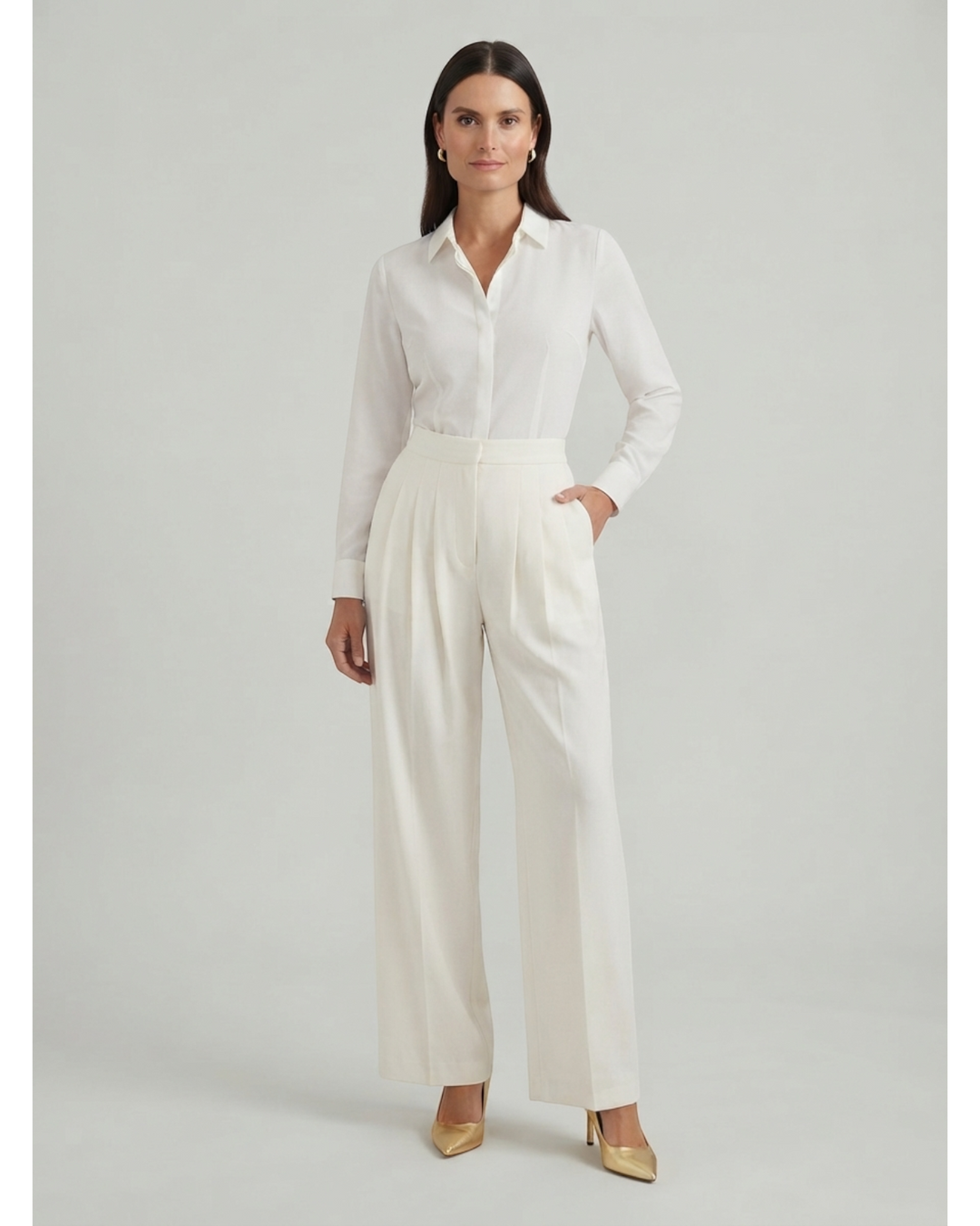 Luna Moda Sibilla ivory crepe palazzo trousers with meticulous pleats and a slim tailored fit worn by a model