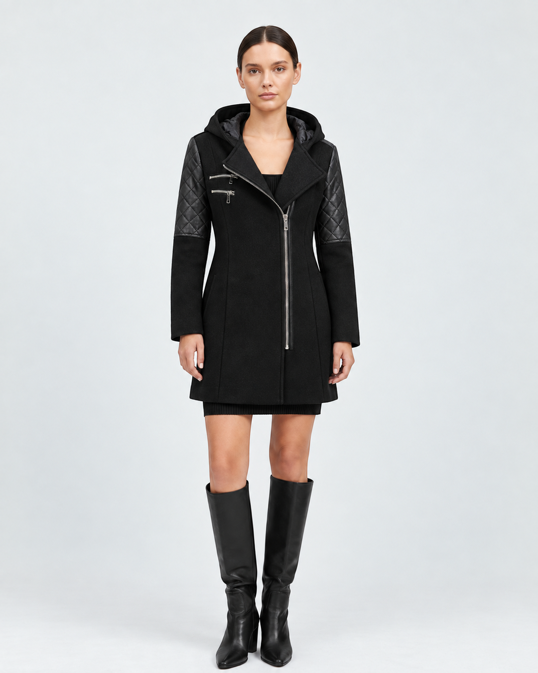 Model wearing a black Luna Moda Sibilla winter jacket with an asymmetric zip, hooded collar, and quilted sleeves.