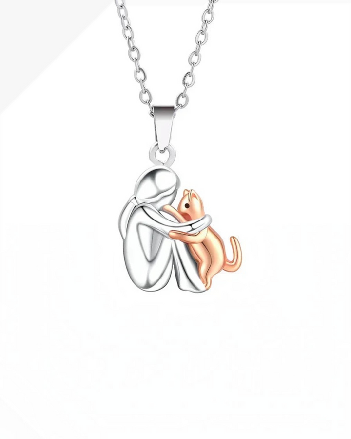 Luna Moda silver and gold cat hug pendant necklace featuring a stylized person embracing a cat on a 42cm chain