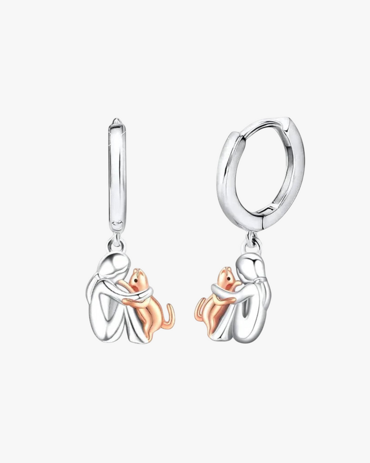 Luna Moda cat hug hoop earrings in silver and rose gold, featuring a woman embracing a cat in a delicate design.