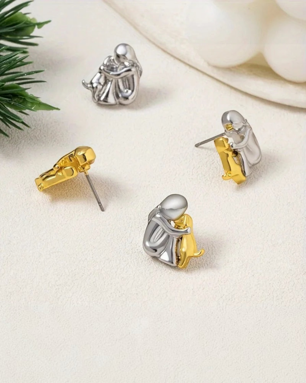 Luna Moda two-tone silver and gold dog hug stud earrings featuring a person embracing a dog