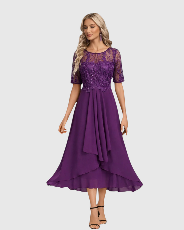 Luna Moda midi dress in deep purple with short lace sleeves, sheer neckline, and a flowing layered skirt.