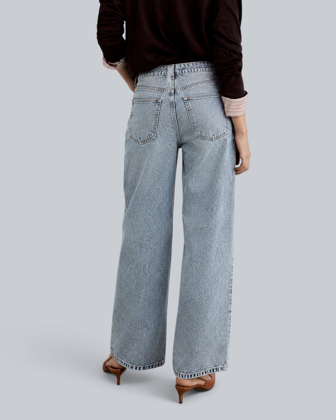 Luna Moda high-waisted baggy jeans in vintage washed light blue denim, back view on a model with brown heels.