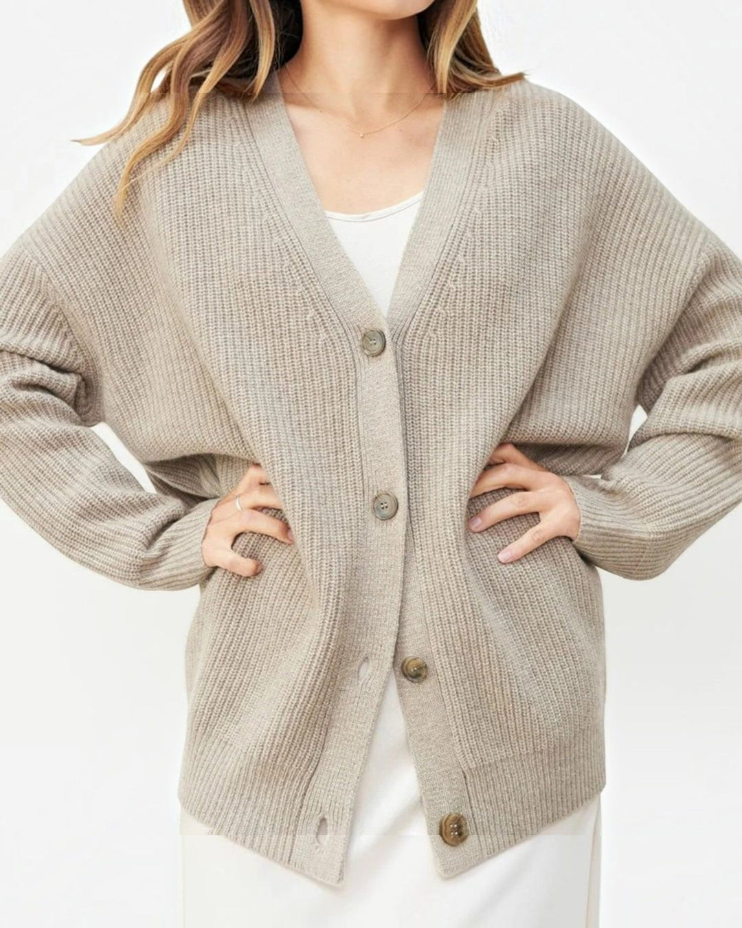 Luna Moda beige cashmere V-neck cardigan with ribbed texture and button-up front worn by a woman