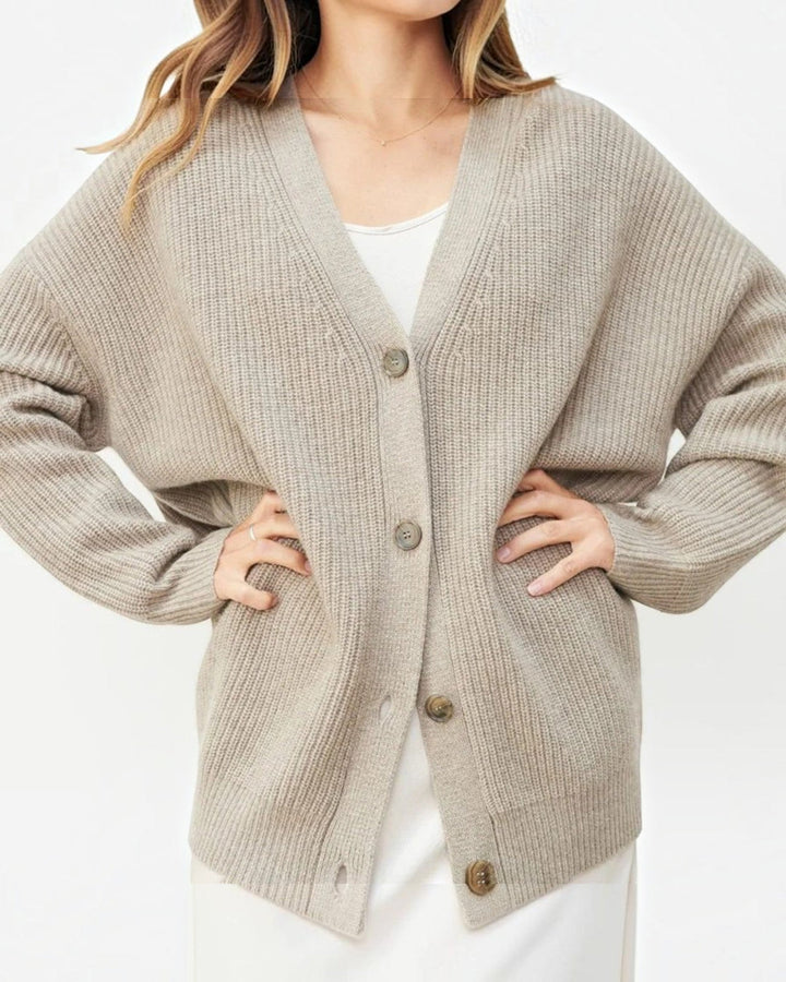 Luna Moda beige cashmere V-neck cardigan with ribbed texture and button-up front worn by a woman