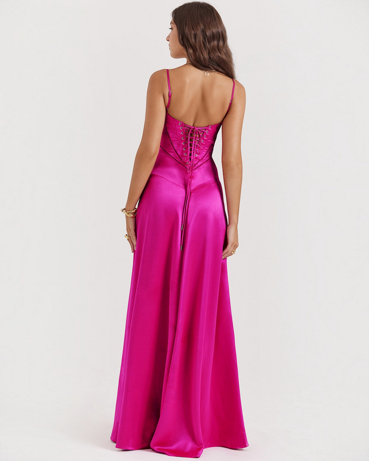 Luna Moda Noelle fuchsia satin evening gown with corset-style lace-up back and flowing skirt on a model