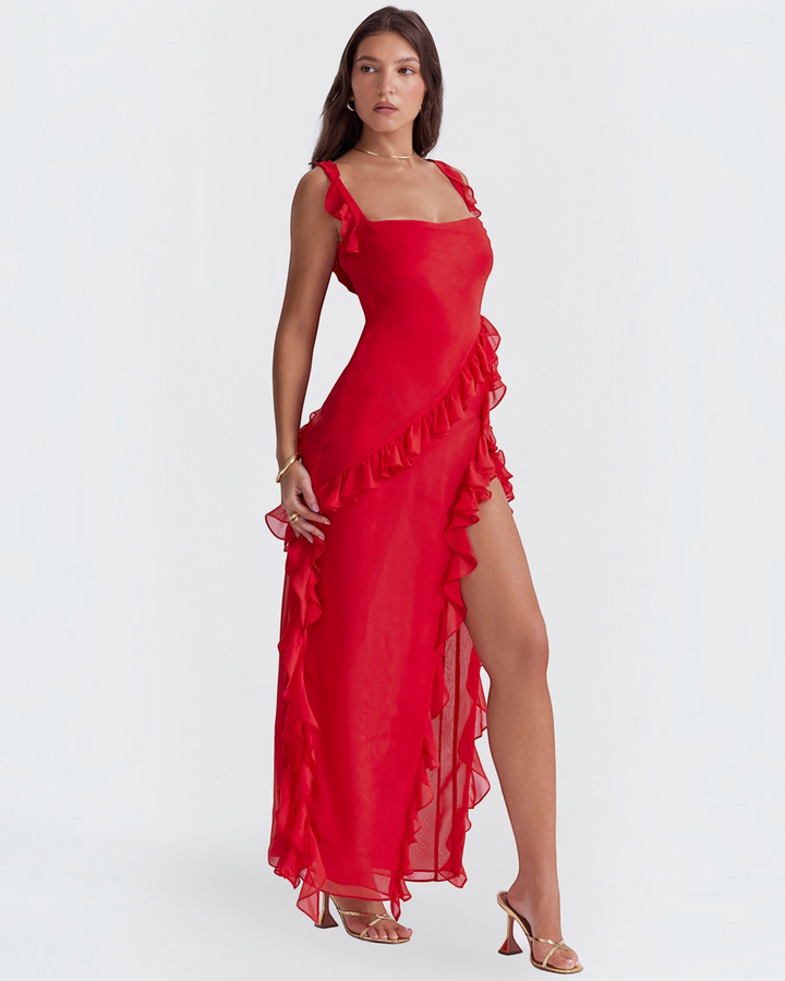 Luna Moda Andrea red maxi dress with ruffles and a high side slit worn by a model with gold heels