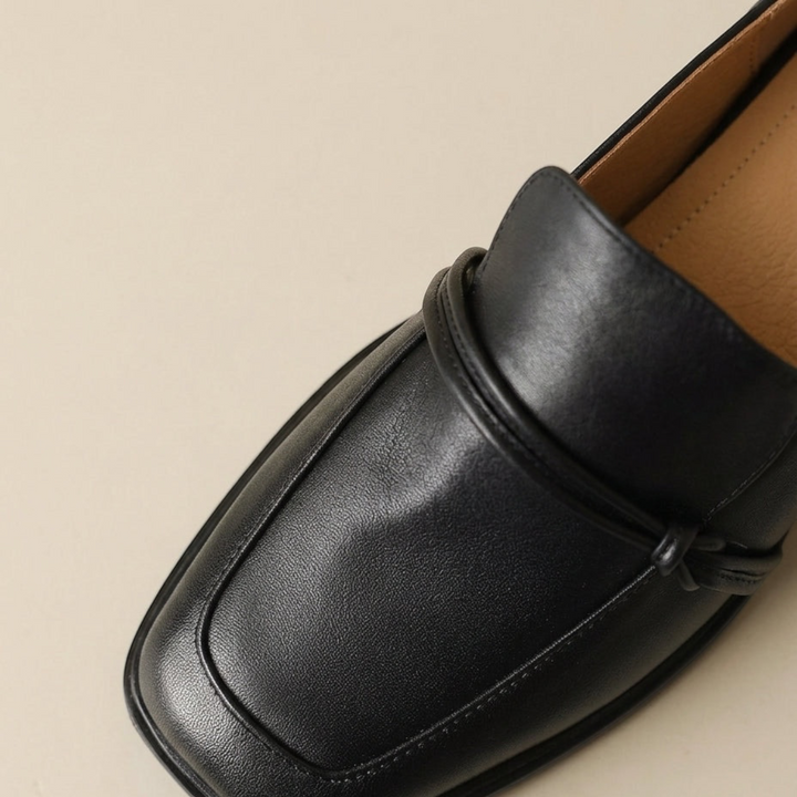 Luna Moda black leather loafers featuring a square toe and delicate decorative bow detail on the upper.
