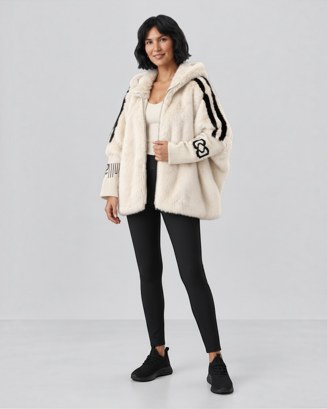 Luna Moda cream faux fur hooded jacket with black contrast stripes and sleeve detailing worn by a model.