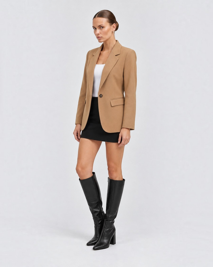 Luna Moda Margarida blazer in camel premium fabric worn by a model with a black mini skirt and knee-high boots