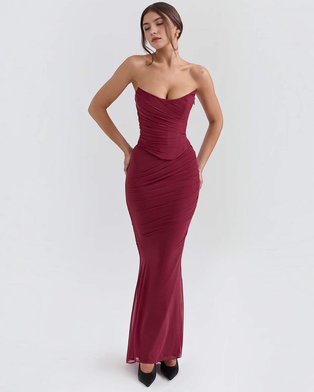Luna Moda Seraphina burgundy mesh corset dress with draped bodice and floor-length silhouette on a model