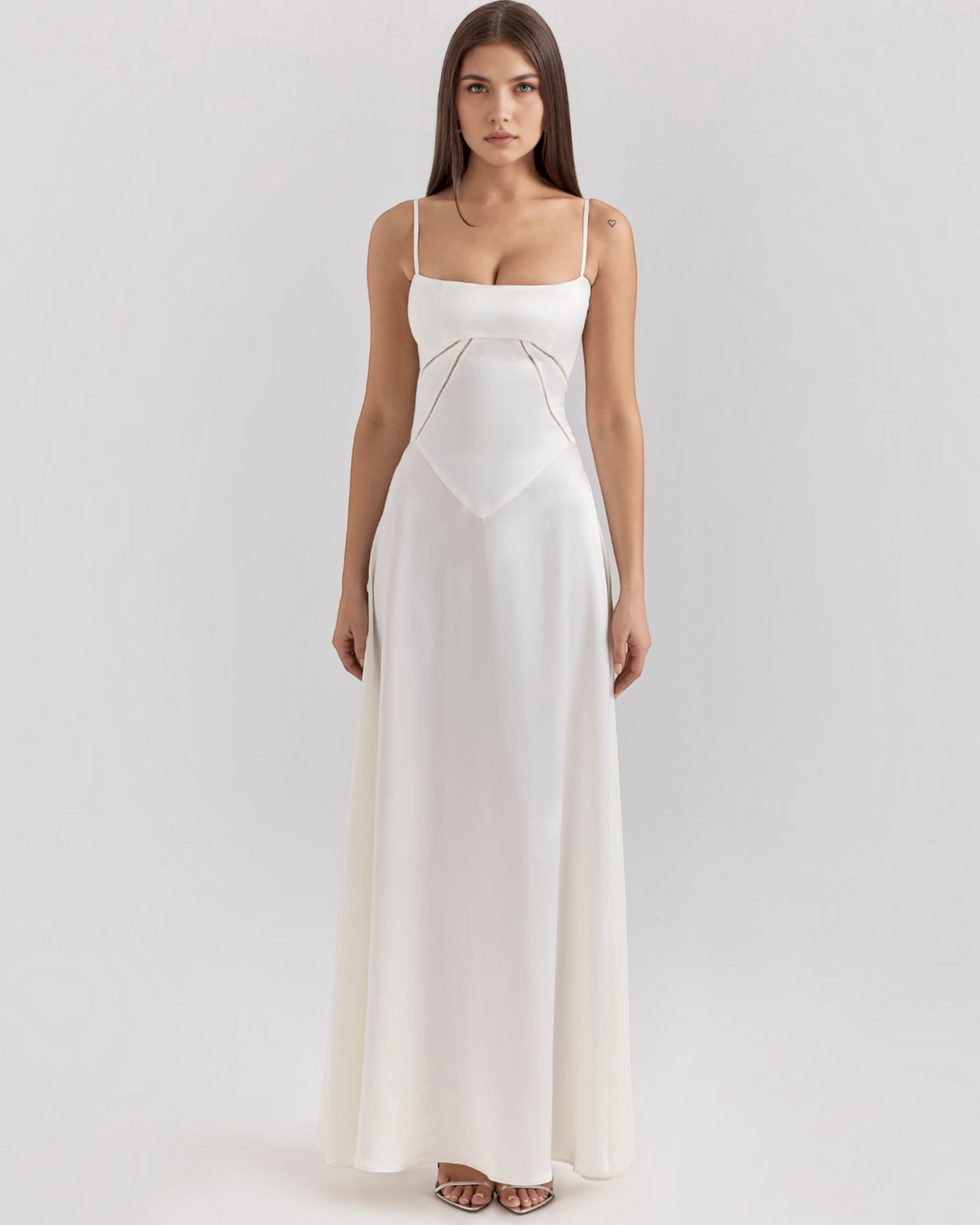 Luna Moda Noelle white bustier evening dress with a fitted bodice, flowing skirt, and thin straps on a model.
