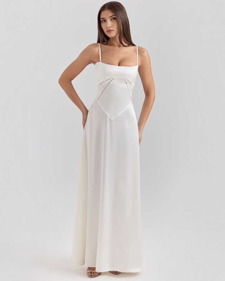Luna Moda Noelle white bustier evening gown with thin straps and a flowing skirt worn by a model