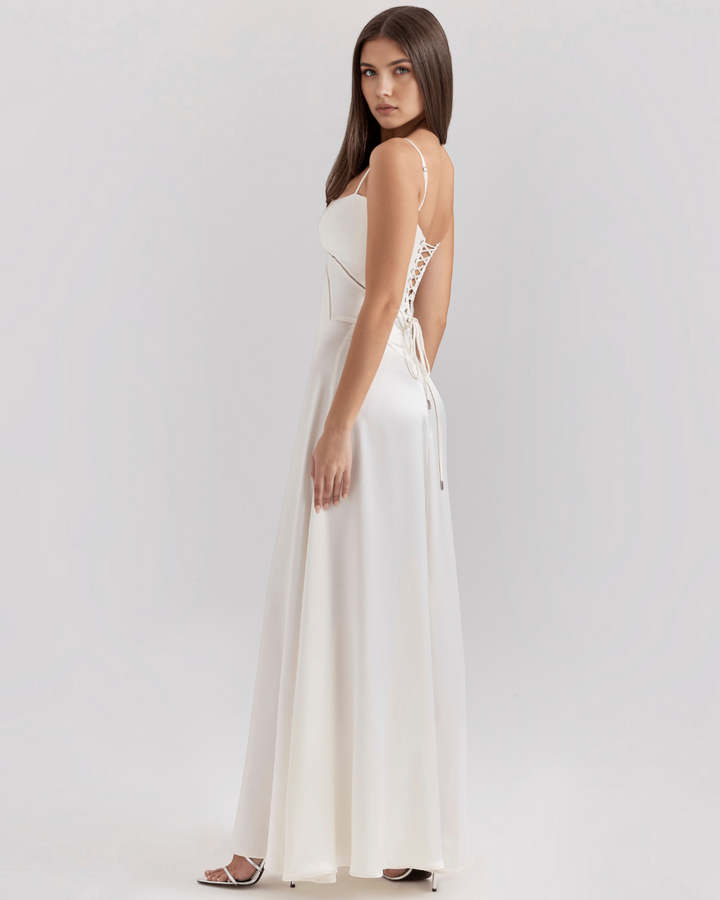 Luna Moda Noelle white evening gown with a corset-style lace-up back, spaghetti straps, and a flowing skirt.