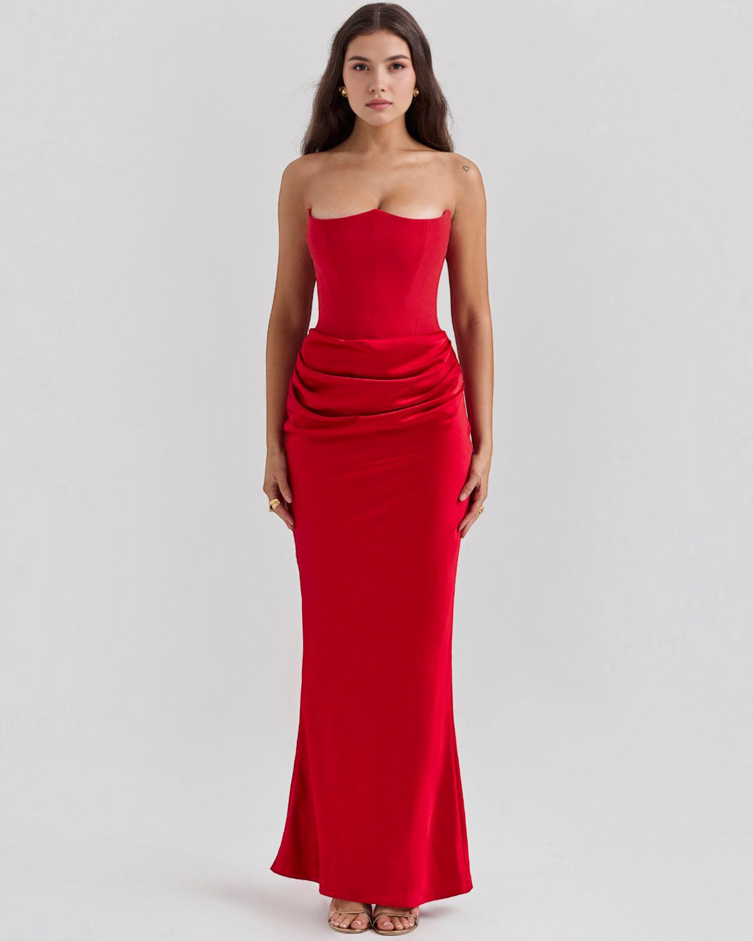 Luna Moda Serena red strapless evening gown with a corset bodice and draped satin skirt on a model