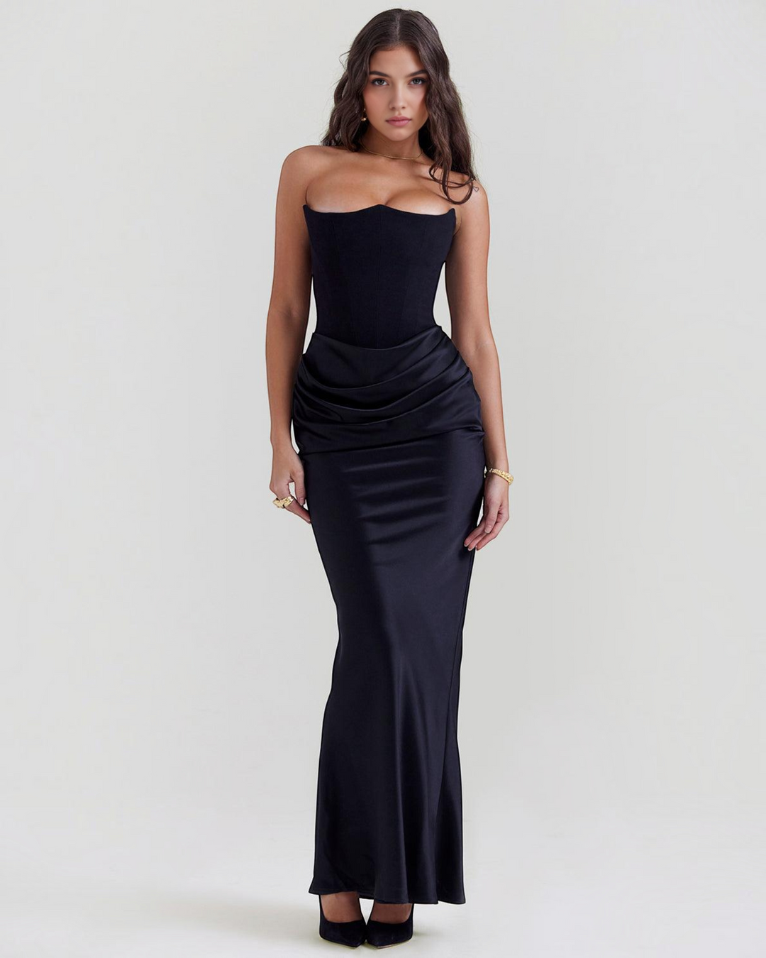 Luna Moda Serene black strapless satin gown with a fitted bodice and draped waist detail worn by a model