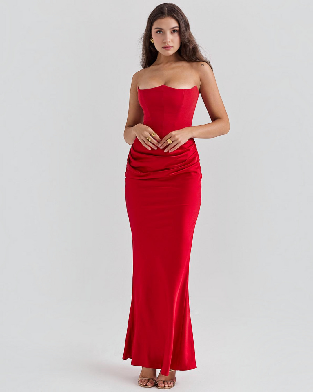 Luna Moda strapless red satin gown with a fitted bodice and draped waist detail worn by a model