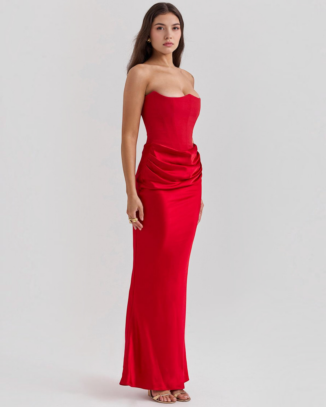 Luna Moda Serena red strapless evening gown with a corset bodice and draped satin skirt on a model