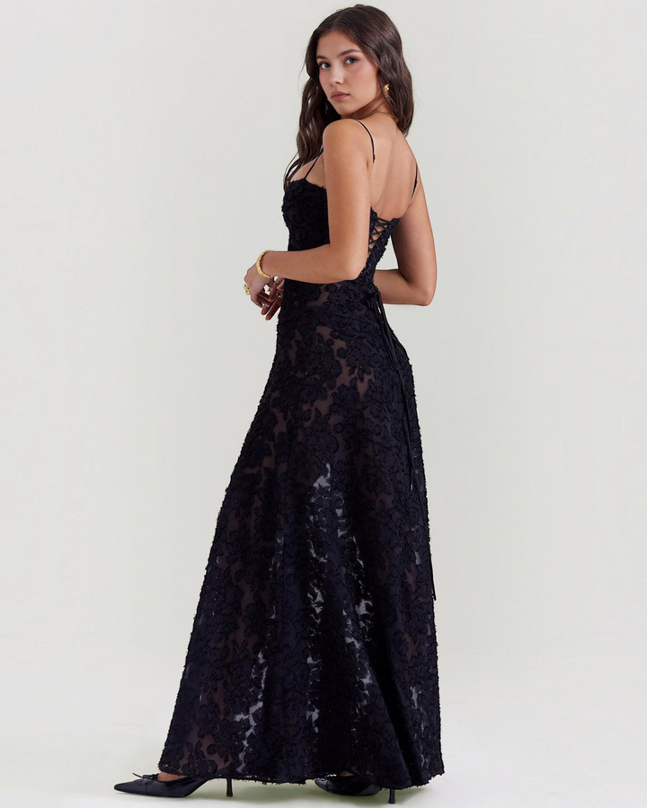 Luna Moda black evening dress with floral velvet overlay, spaghetti straps, and lace-up back detail on a model