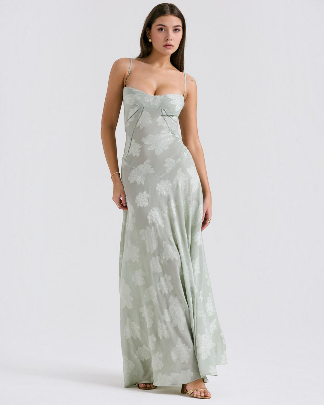 Model wearing Luna Moda Noir Seren sage green floral velvet overlay maxi evening dress with delicate spaghetti straps