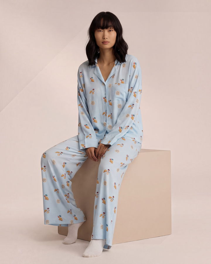 Luna Moda light blue button-up pajama set with breakfast-themed print, featuring a relaxed shirt and wide-leg pants.