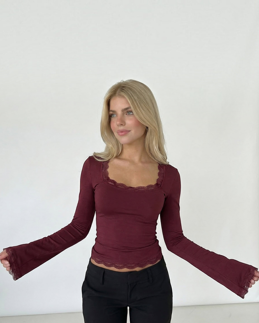 Luna Moda burgundy long-sleeve top with square neckline and delicate lace trim worn by a blonde model