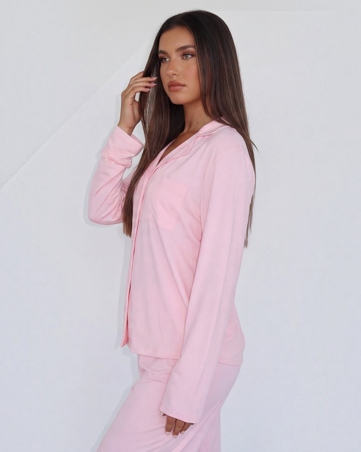 Luna Moda blush pink button-down lounge shirt and matching wide-leg pants worn by a model in a relaxed pose.