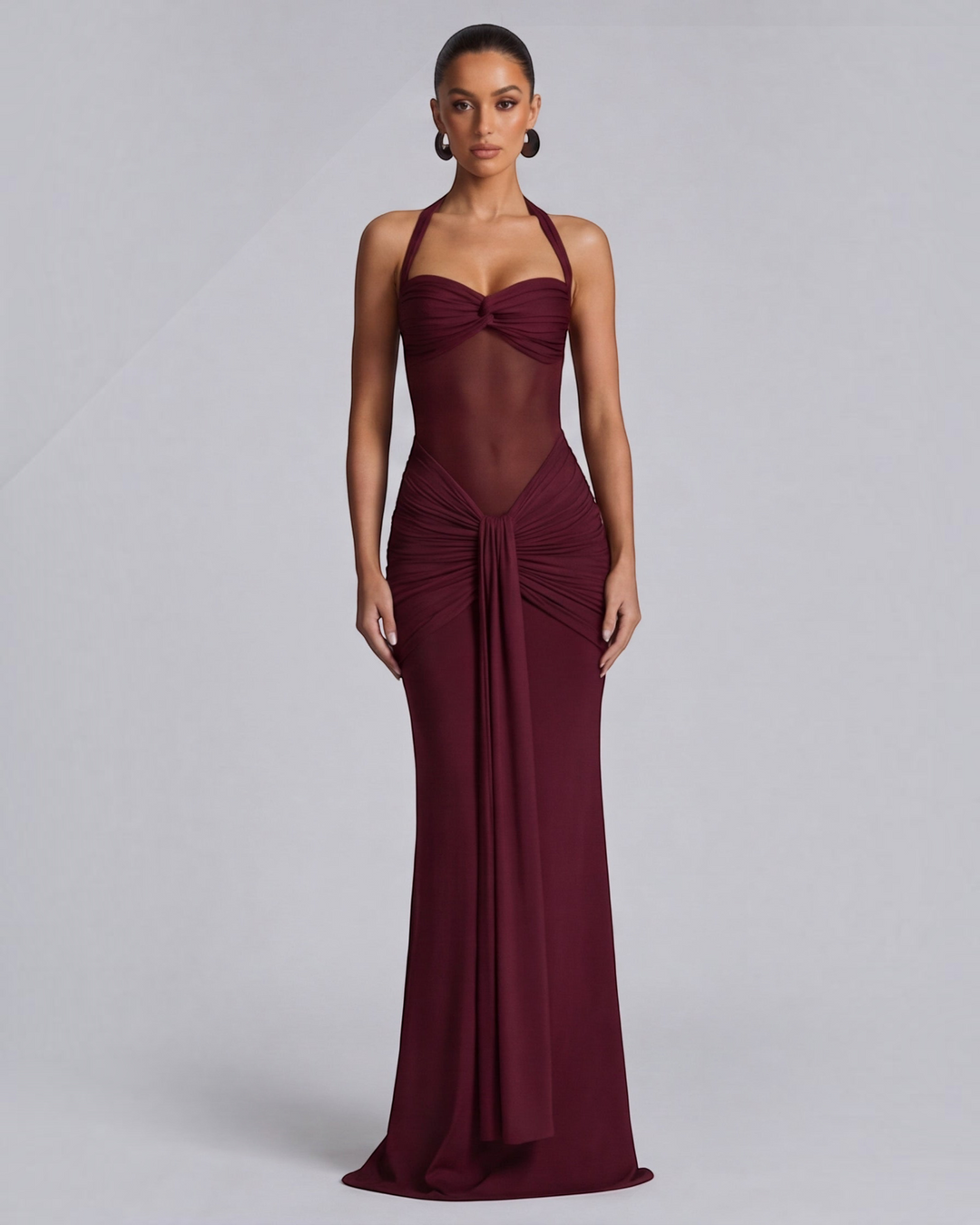 Luna Moda wine red mermaid gown featuring a mesh waist panel, halter neckline, and elegant ruched hip detailing.