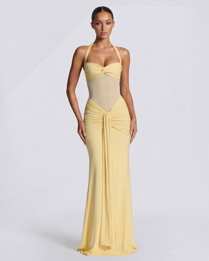 Luna Moda yellow mermaid gown with mesh waist detail and ruched hips on a model against a white background
