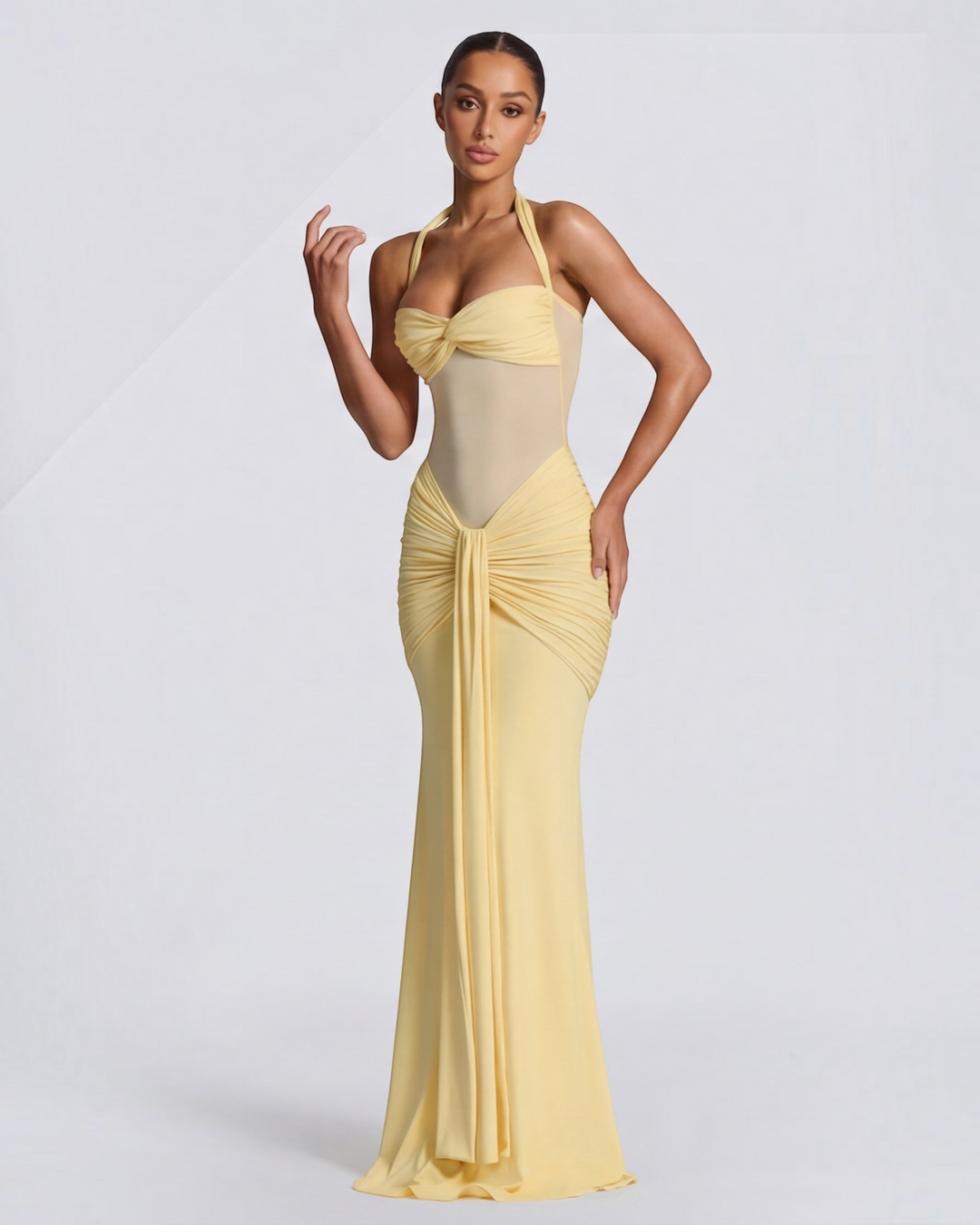 Luna Moda yellow mermaid gown with mesh waist detail and ruched hips on a model against a white background