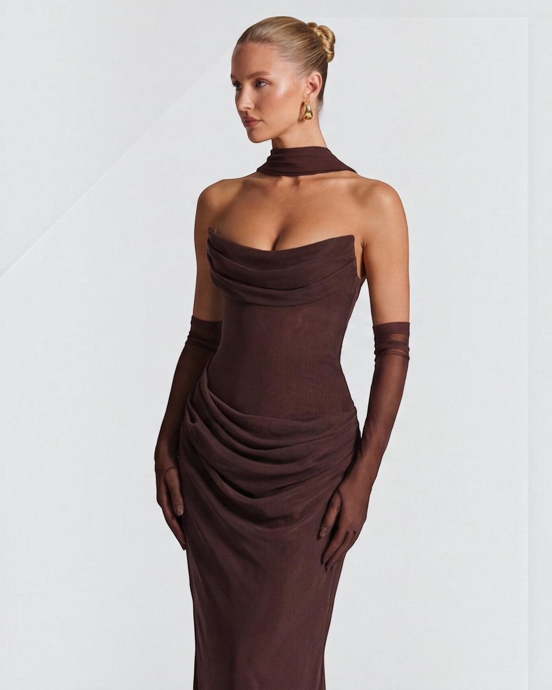 Luna Moda brown maxi dress with draped bodice and sculpting silhouette worn by a model with matching sheer gloves.