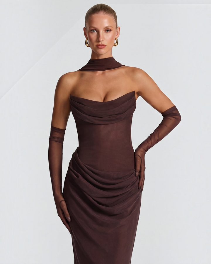 Luna Moda brown sculpting maxi dress with draped bodice and sheer mesh fabric on a model with elegant accessories.