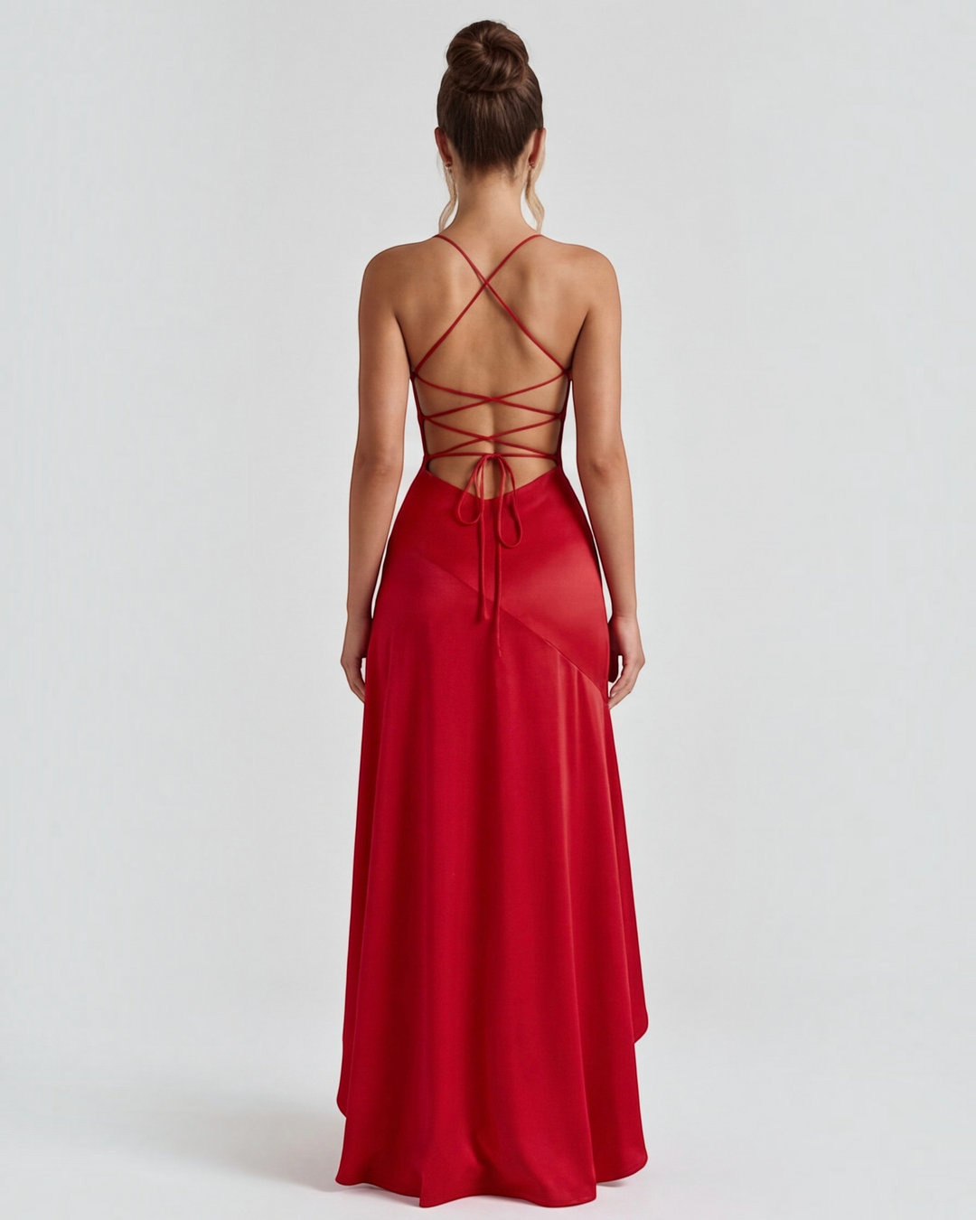 Luna Moda red satin evening gown with a high slit, open back, and adjustable crisscross tie straps on a model