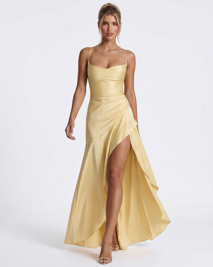 Luna Moda pale yellow satin evening gown with a draped neckline, high leg slit, and adjustable crisscross straps.