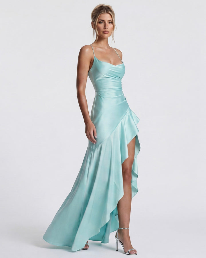 Luna Moda Muse satin gown in pale turquoise with a draped neckline, high slit, and ruffled hem on a model.