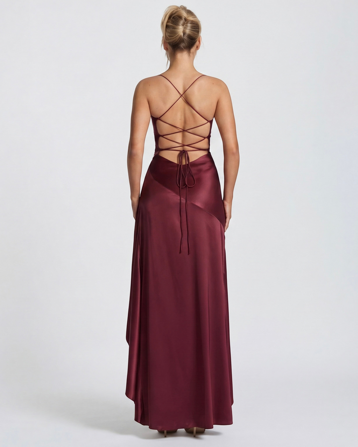Back view of a Luna Moda red satin evening gown with a lace-up open back, spaghetti straps, and draped skirt.