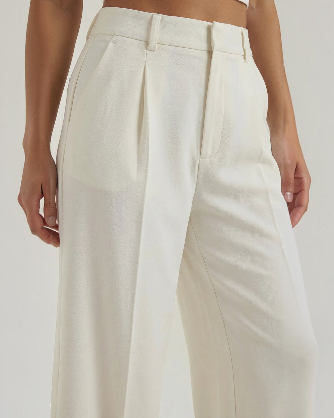 Luna Moda high-waisted cream palazzo trousers with pleated details and a fluid, wide-leg silhouette.