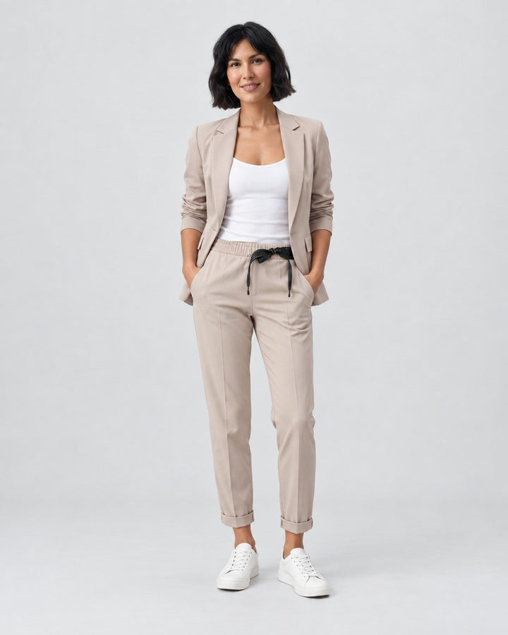 Luna Moda Adriana beige fluid blazer and elastic waist trousers set worn by a woman with white sneakers