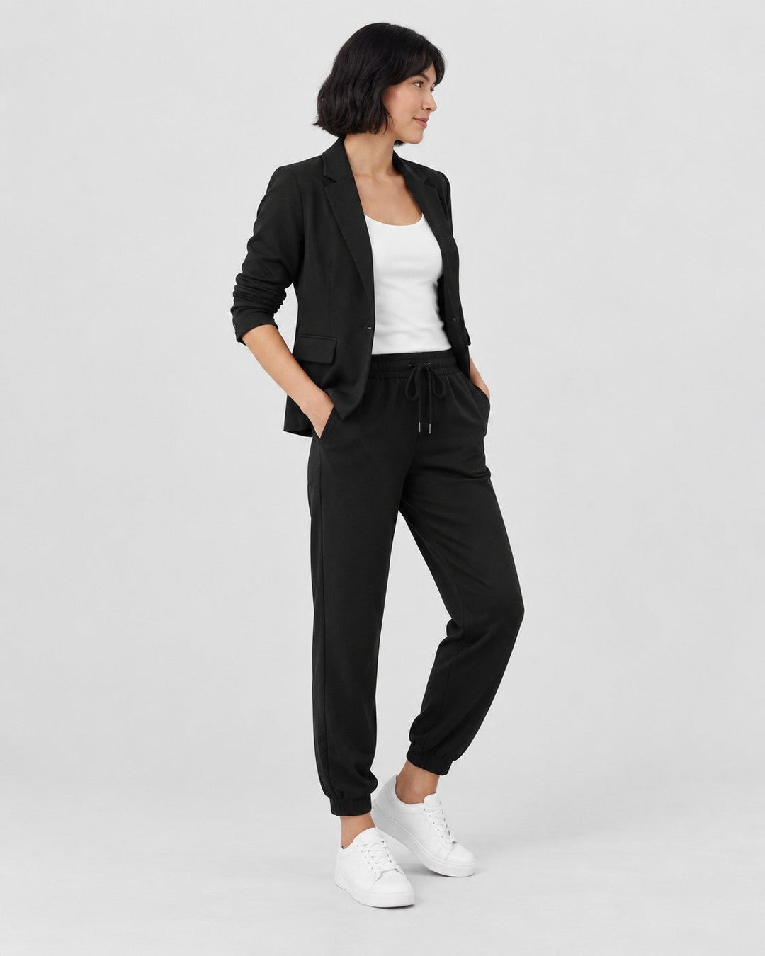 Luna Moda Adriana black fluid blazer and elastic waist jogger pants set worn by a woman with white sneakers