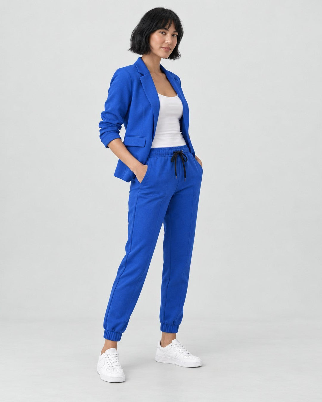 Luna Moda Adriana royal blue fluid blazer and elastic waist jogger pants set worn by a woman with white sneakers
