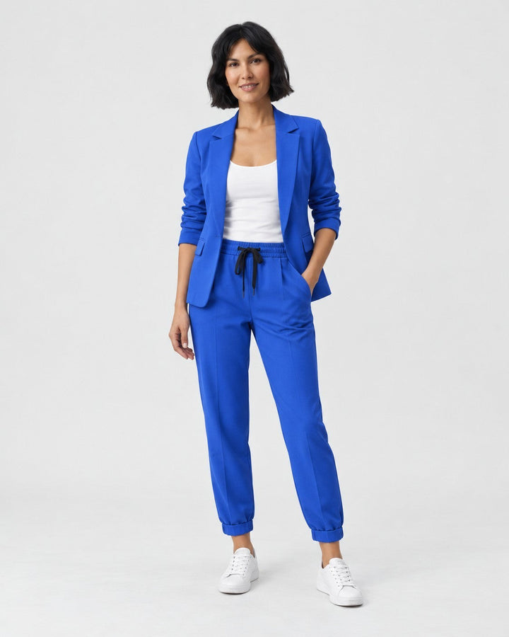 Luna Moda Adriana royal blue fluid blazer and elastic waist trousers set worn by a woman with white sneakers