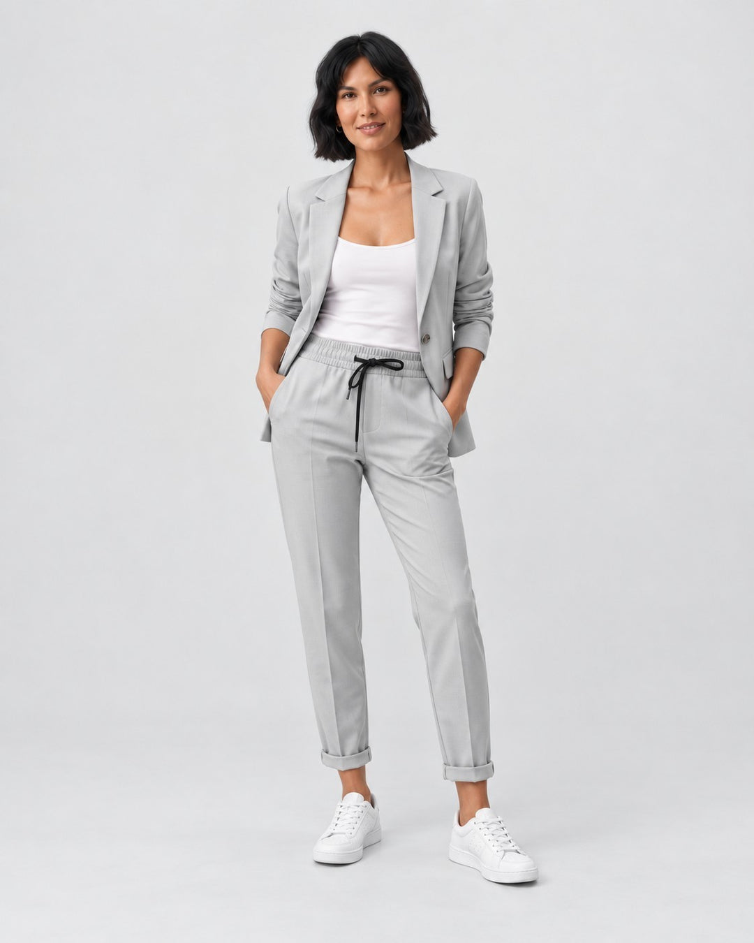 Luna Moda Adriana light grey fluid blazer and elastic waist trousers set worn by a woman with white sneakers