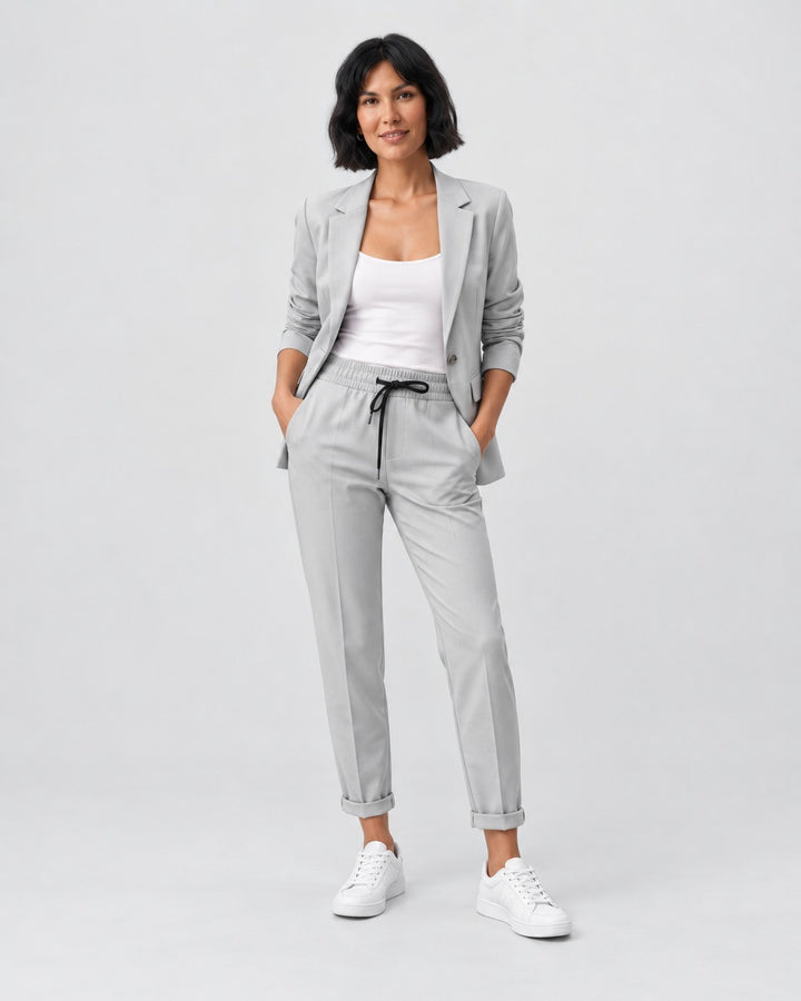 Luna Moda Adriana light grey fluid blazer and elastic waist trousers set worn by a woman with white sneakers