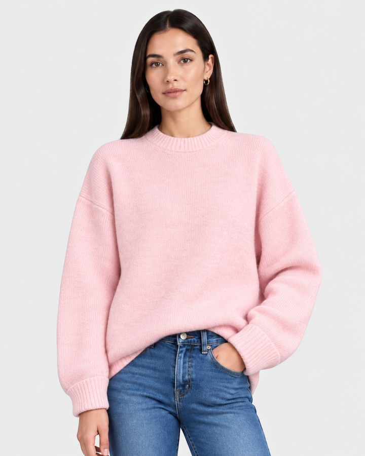 Luna Moda Adriana pastel pink oversized sweater with a boat neckline worn by a model with blue jeans