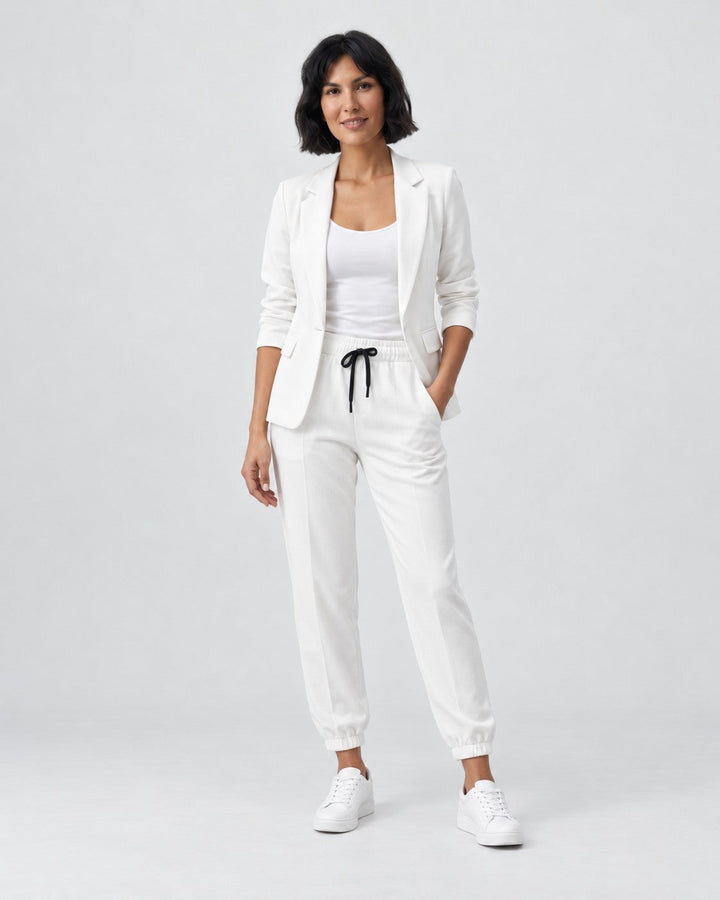 Luna Moda Adriana white fluid blazer and elastic waist trousers set worn by a model with white sneakers
