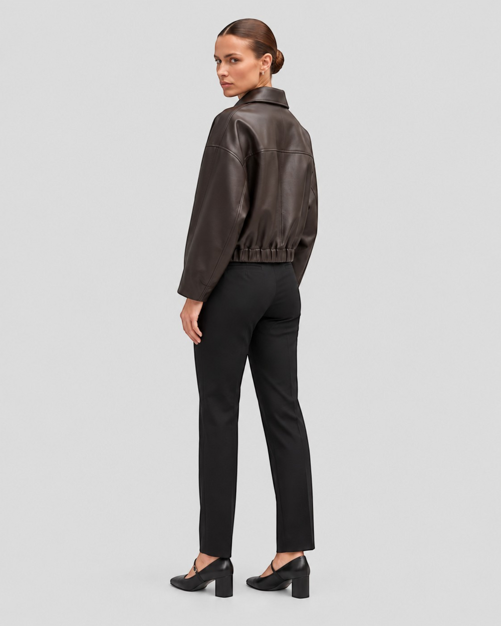 Luna Moda Alessandra brown faux leather jacket with adjustable waist belt worn by a model, back view