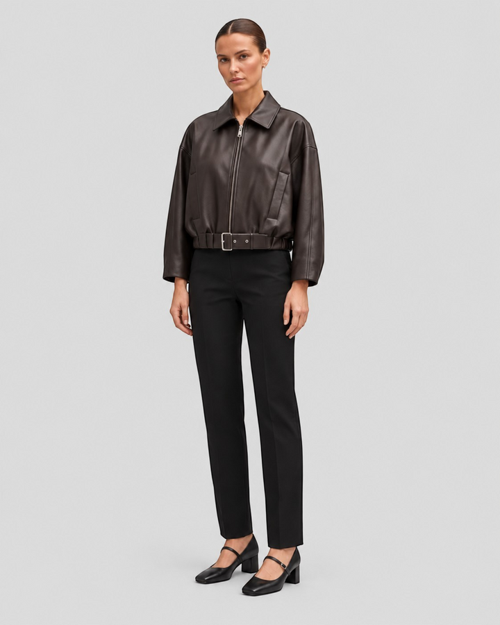 Luna Moda Alessandra dark brown faux leather jacket with a zip front and adjustable waist belt on a model